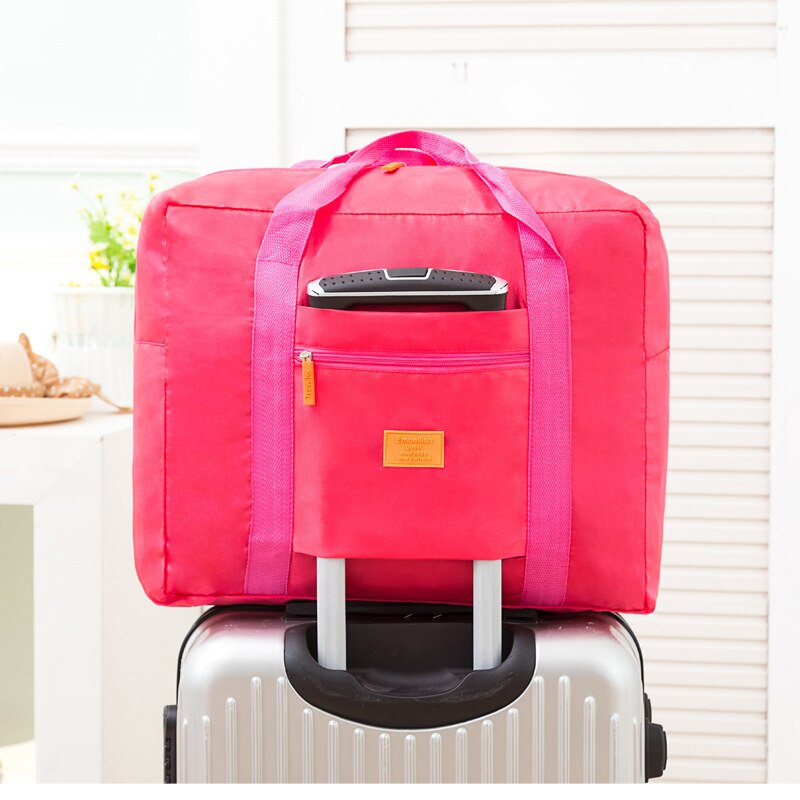 Airplane bag aircraft bag waterproof portable luggage bag large capacity clothing travel storage bag Korean folding luggage bag: Pink