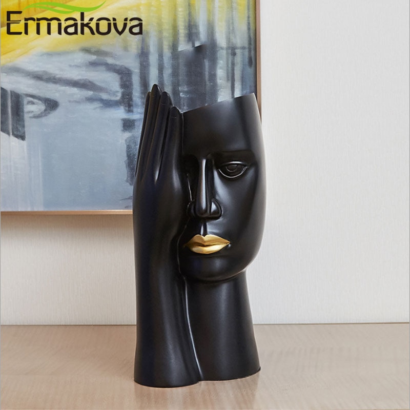 Ermakova minimalistisk portræt vaser harpiks skulptur sort menneskehoved vase gryde kontorbord blomsterarrangement boligindretning.