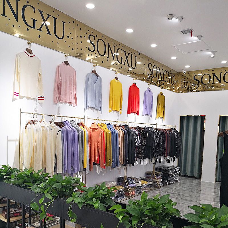 Gouden metalen haken plank muur hangende hangers winkels tonen meubilair decor kleding jas jurk pak ondergoed display rek