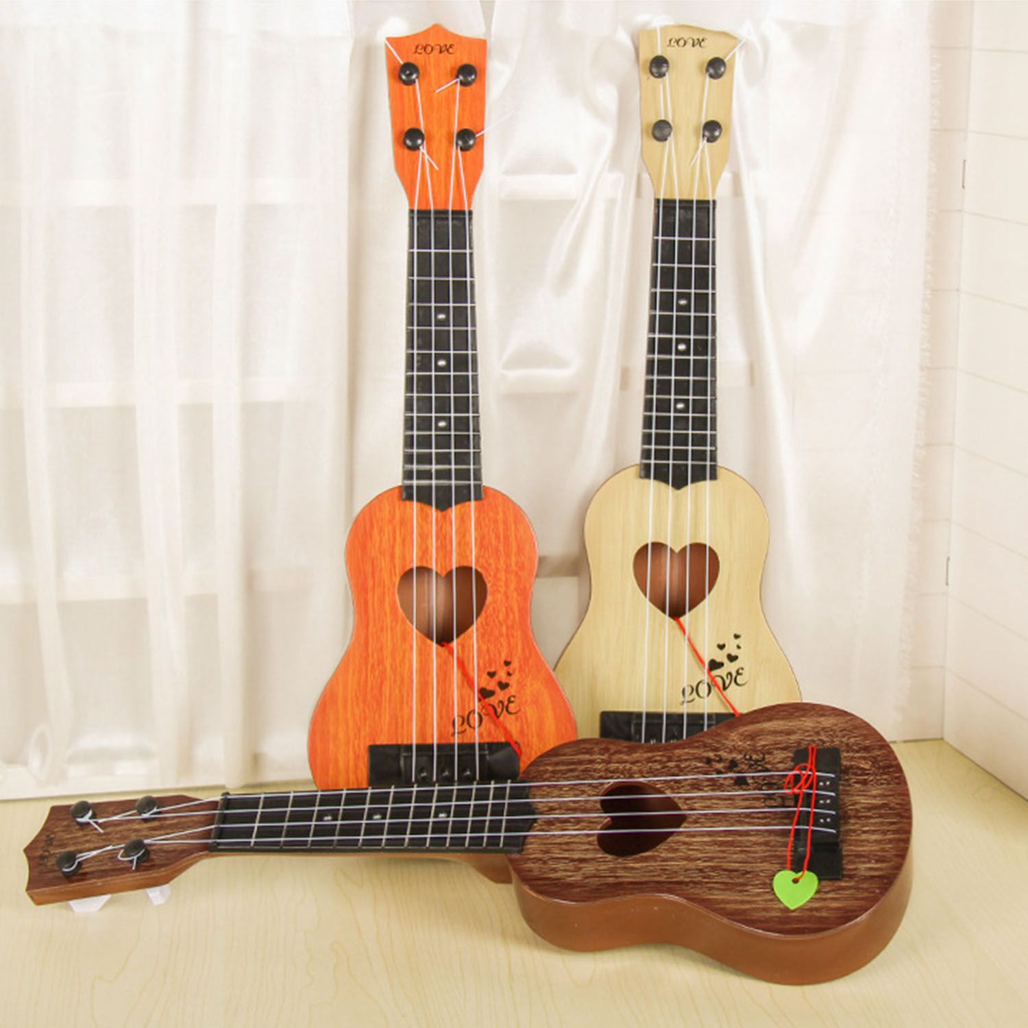 Musikinstrument mini ukulele børn guitar legetøj skole spille spil farve løb