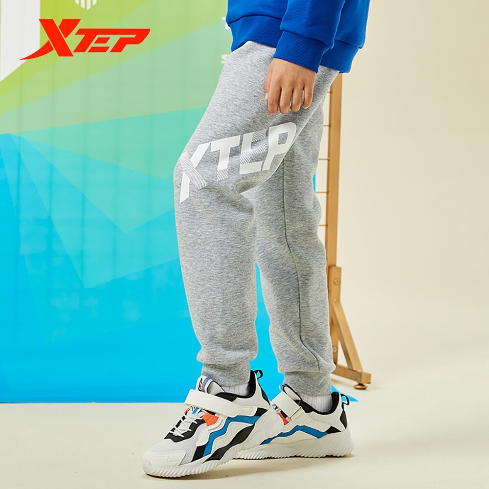 Spodnie dziecięce Xtep 2020 jesienne i zimowe spodnie chłopięce plus kaszmir ciepły tendencja zwykły spodnie sportowe 680426639028