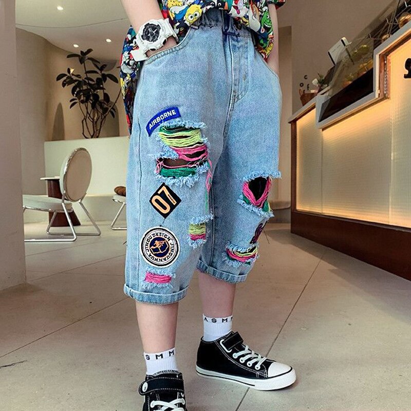 Pantalones vaqueros rasgados para niños y niñas de 2 a 12 años, sección delgada, ropa exterior juvenil, pantalones recortados de Graffiti, novedad de verano