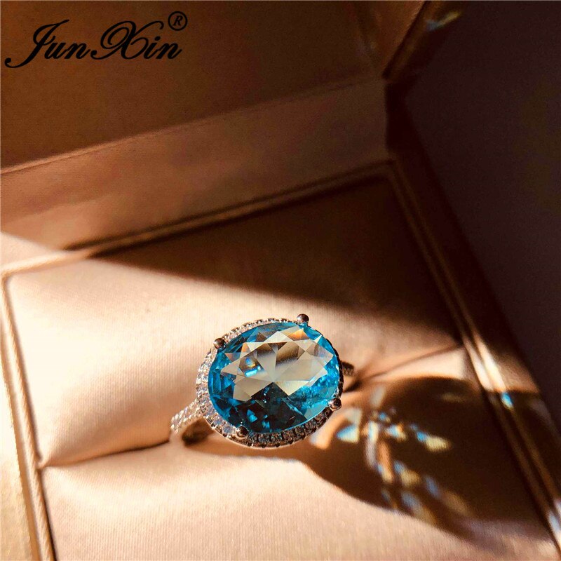 JUNXIN-Anillo de boda de una sola piedra para mujer, sortija de boda de cristal azul Aqua de corte ovalado, joyería de compromiso