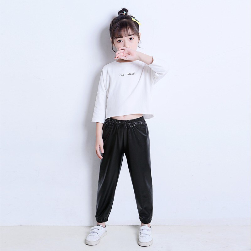 Del bambino del bambino del bambino del bambino della ragazza black stretch in pelle artificiale close-lato di modo allentato pantaloni