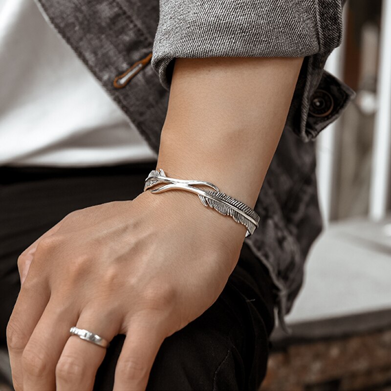 Silbernes retro-Armbinde mit federdesign für herren und jungen – ein trendiges schmuckaccessoire für freunde und Partner.