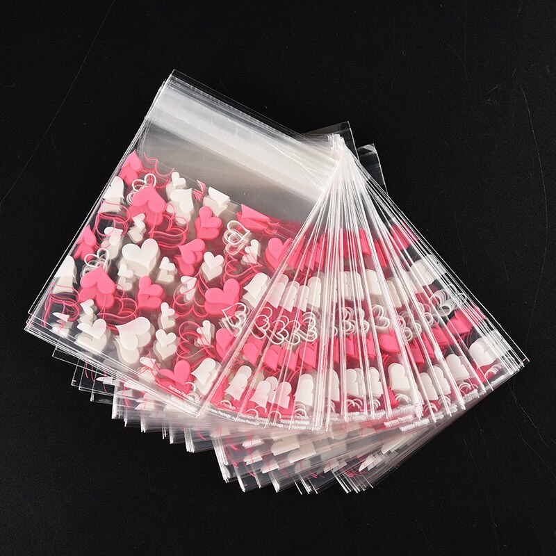100 stuks schattige transparante koekjes- en snoepzakjes in de vorm van harten, zelfklevende kerstverpakkingen, bakverpakkingen en schrijfwarenhouders.