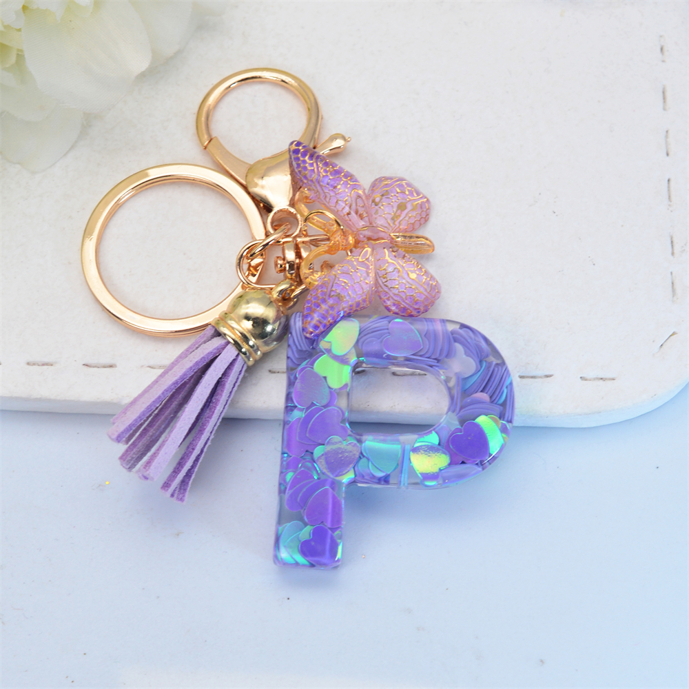 Exquisito llavero de resina brillante azul con 26 iniciales, llavero con colgante de borla de mariposa púrpura con letra de A a Z para mujeres y hombres, para parejas