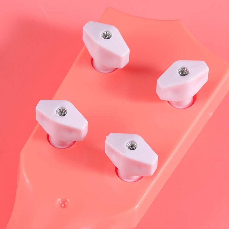 -minigitarr ukulele leksak musikinstrument lärande gitarr leksaker för barn kan locka barns uppmärksamhet (rosa)