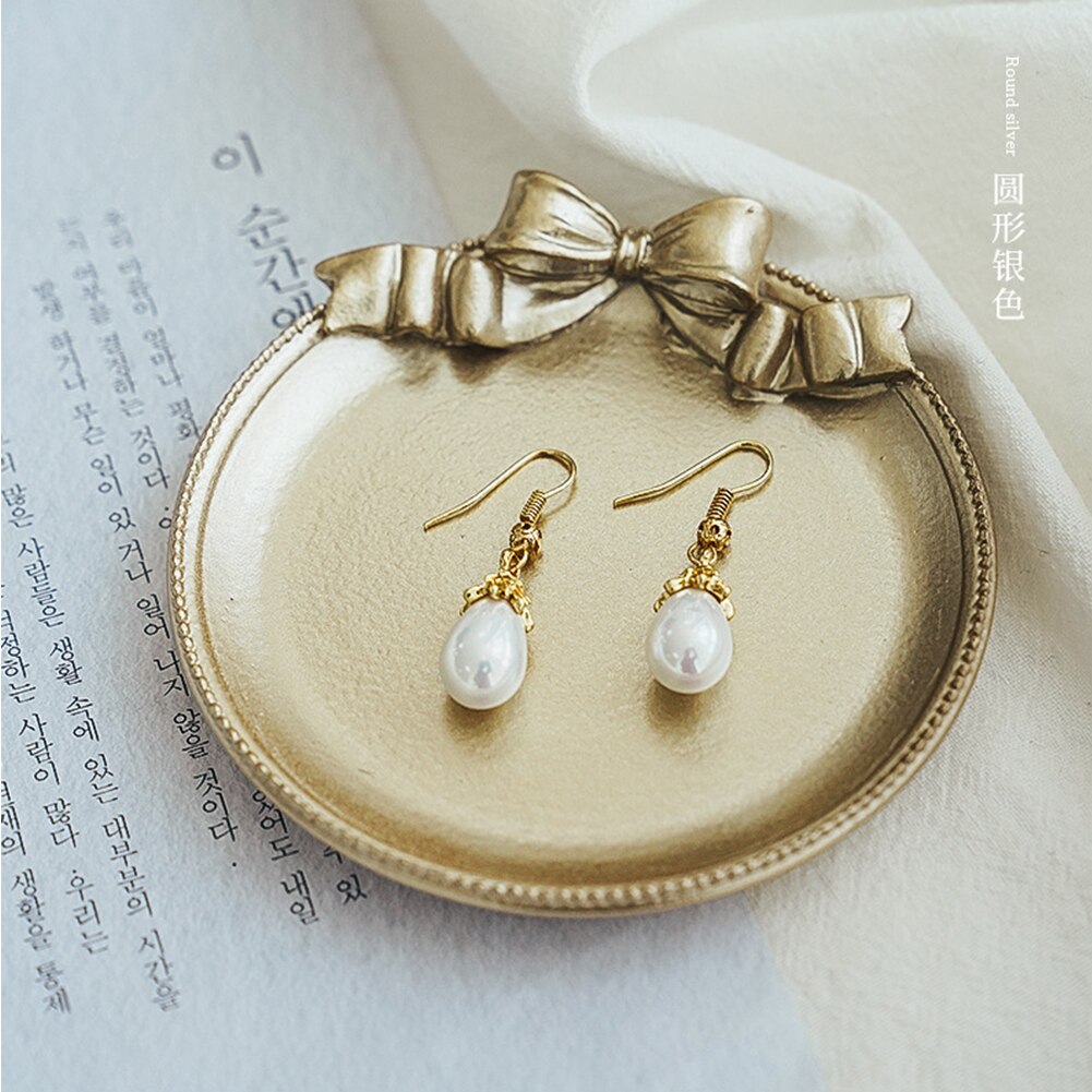 Retro still life photography, photo studio prop, golden vintage plate, dish with bow knot for jewelry, earrings, photography