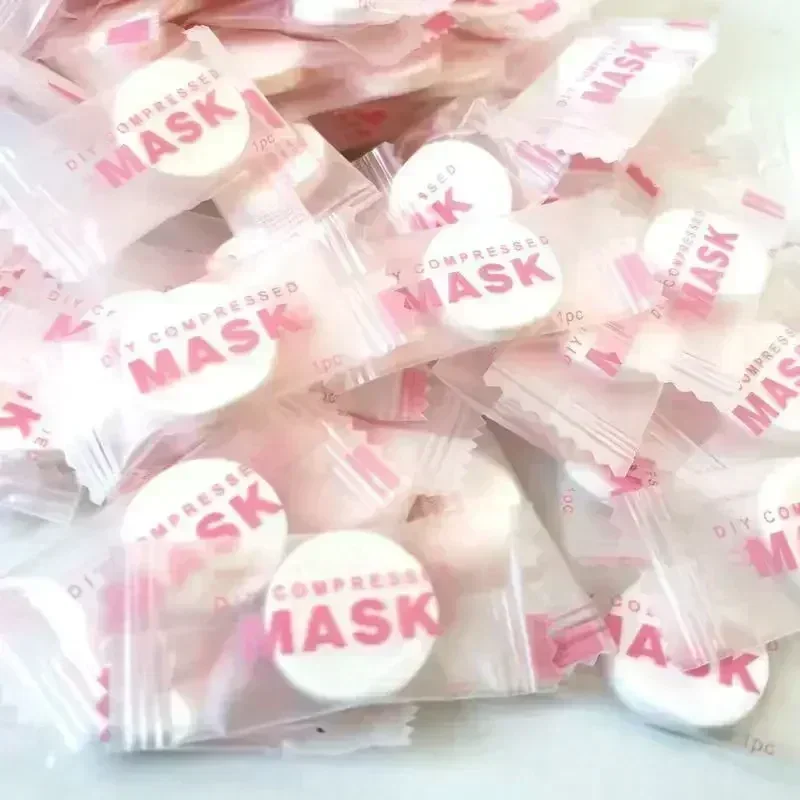 100 st engångs komprimerade ansiktsmasker bärbara resor non-woven ansiktsmasker hudvård bomullsinslagna masker papper: Rosa