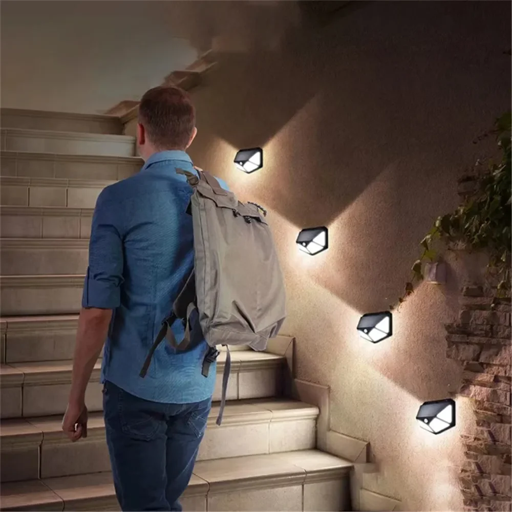 Nyeste solcellelamper udendørs 100 led solcellesensor bevægelseslys 3 tilstande udendørs solcelle trådløs lampe  ip65 vandtætte væglamper