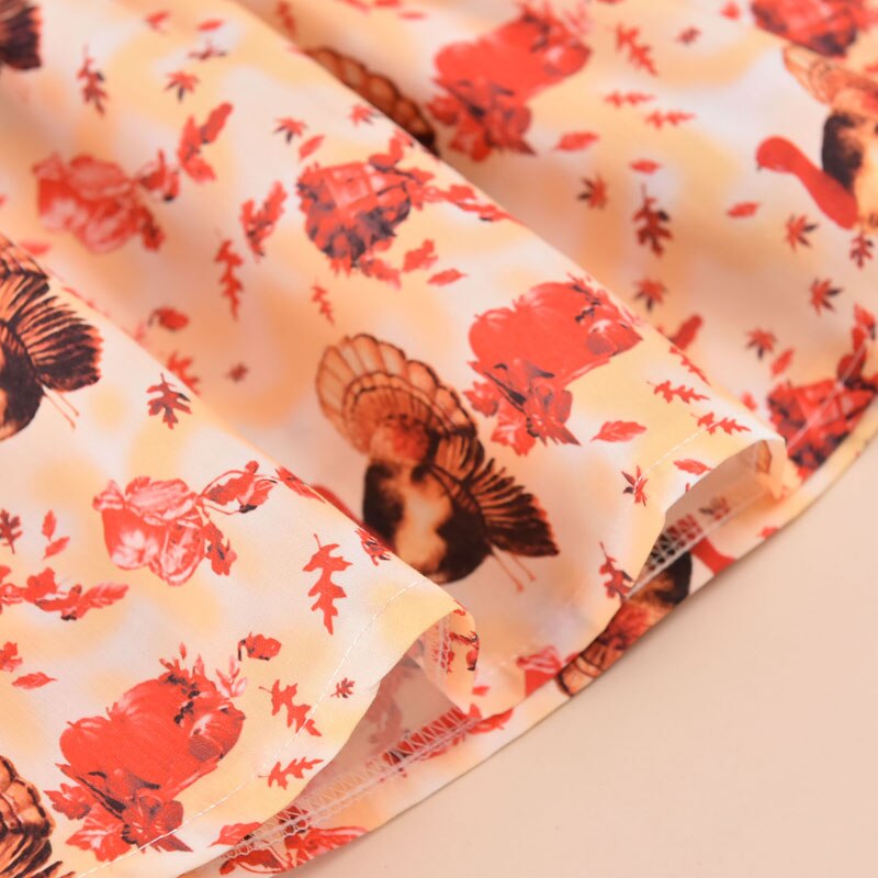 Pudcoco thanksgiving babyjurk met kalkoenprint, ruches, strikversiering, lange mouwen met bloemblaadjes en ronde hals.