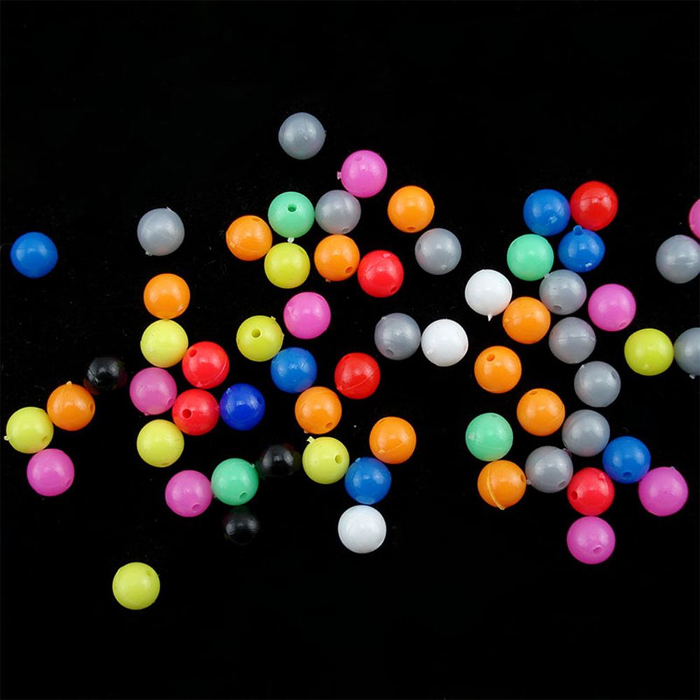 Colorful fishing rig beads displayed on a black background