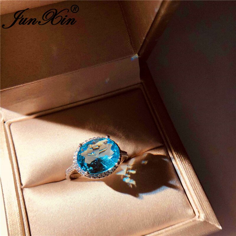 JUNXIN-Anillo de boda de una sola piedra para mujer, sortija de boda de cristal azul Aqua de corte ovalado, joyería de compromiso