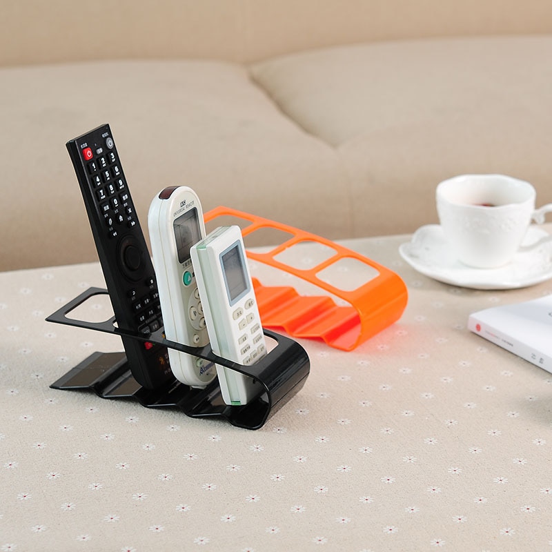 Soporte de plástico para TV, DVD, práctico marco de cuatro mandos a distancia, soporte para teléfono móvil, estante de hasta 4 unidades