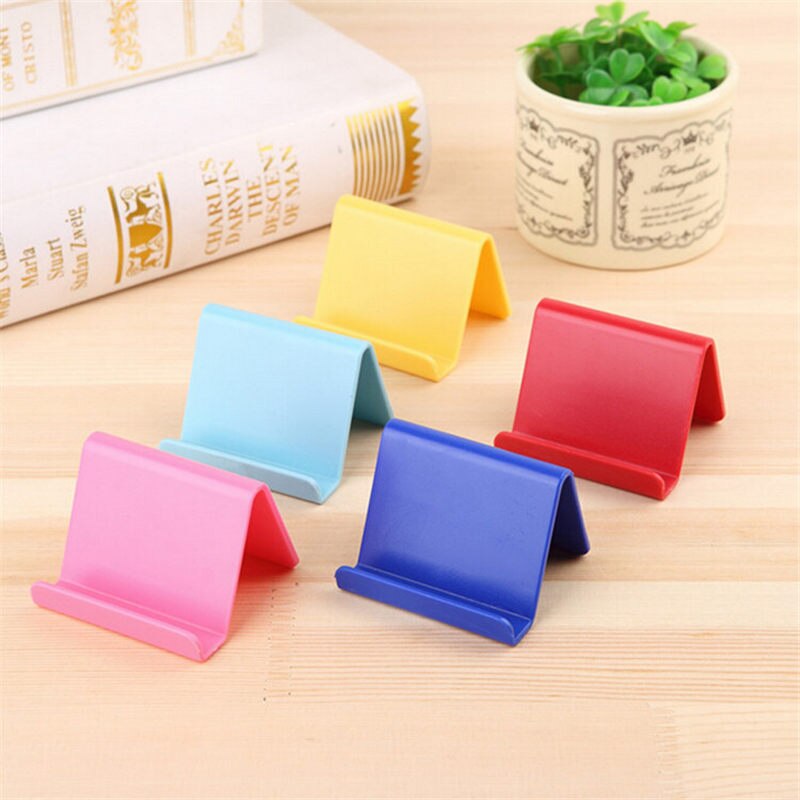 Soporte para teléfono móvil Candy Mini, soporte fijo portátil, suministros para el hogar, plástico, Color aleatorio, 6*4,5 cm
