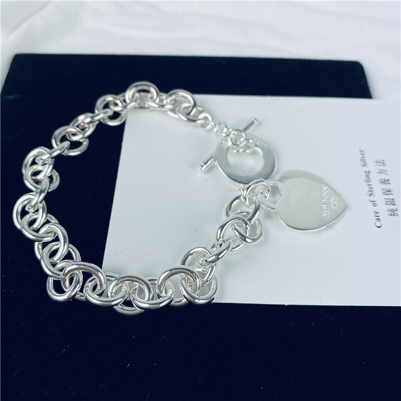 Klassisches silberarmband „argent 925 femme“ mit herzförmigem anhänger, origineller schmuck, hochwertiges herren- und damen-etikett.