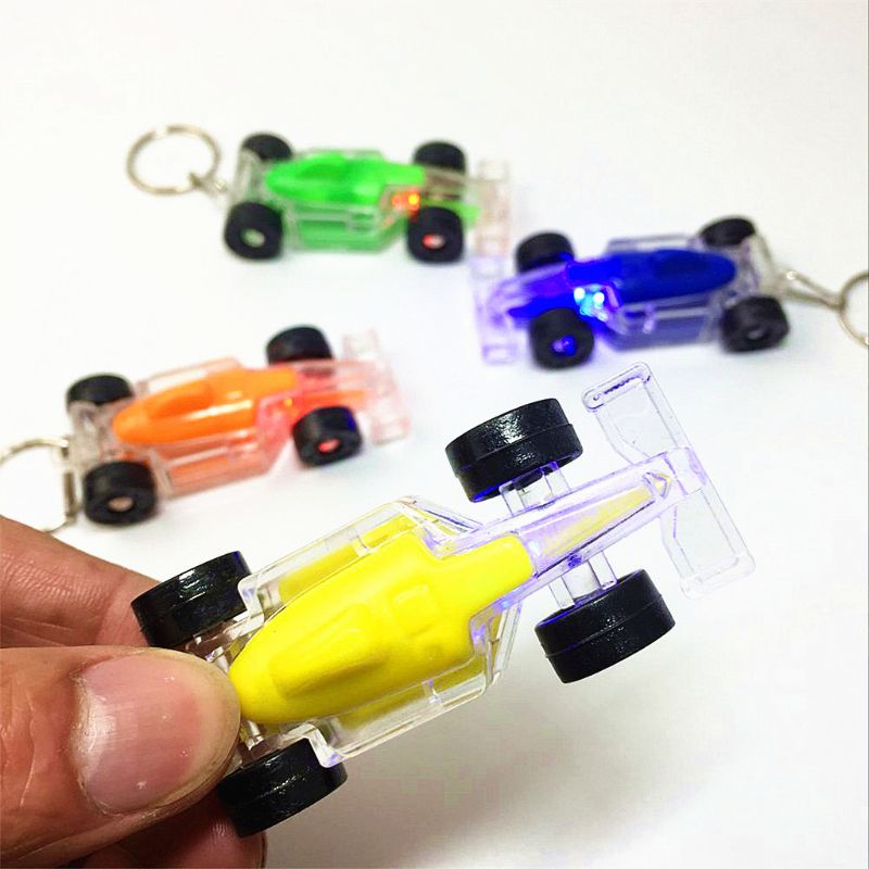 HBB 1PC Bambini mini Lampeggiante Giocattoli Del Fumetto auto A Forma di Portachiavi Veicolo gadget Regalo Torcia Elettrica per Bambini Giocattoli Luminosi di colore Casuale