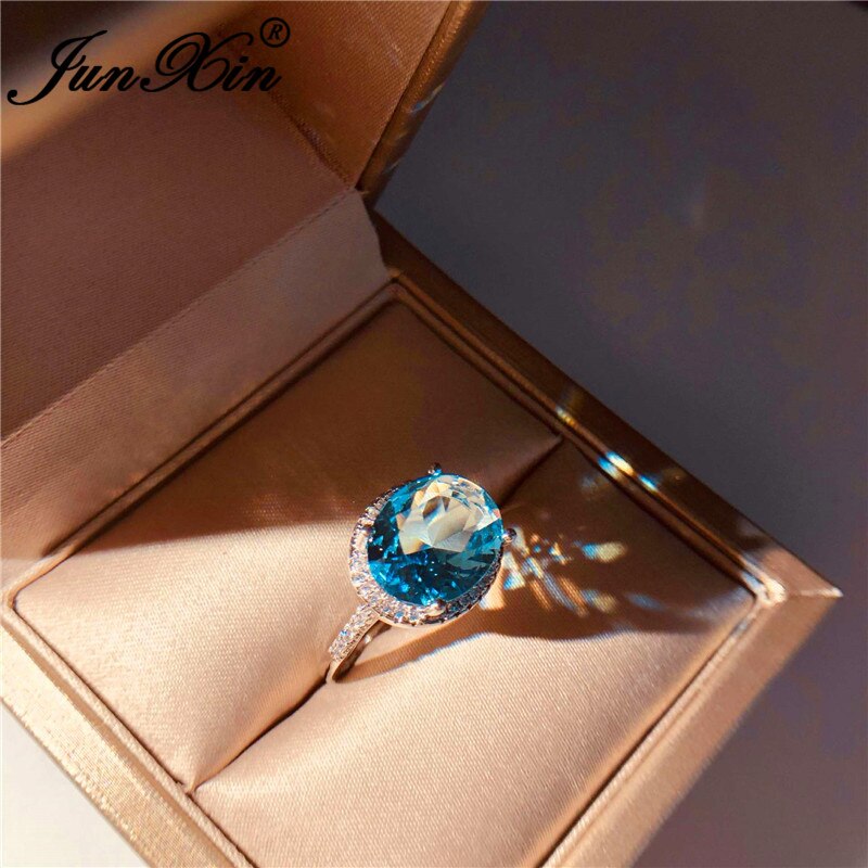 JUNXIN-Anillo de boda de una sola piedra para mujer, sortija de boda de cristal azul Aqua de corte ovalado, joyería de compromiso