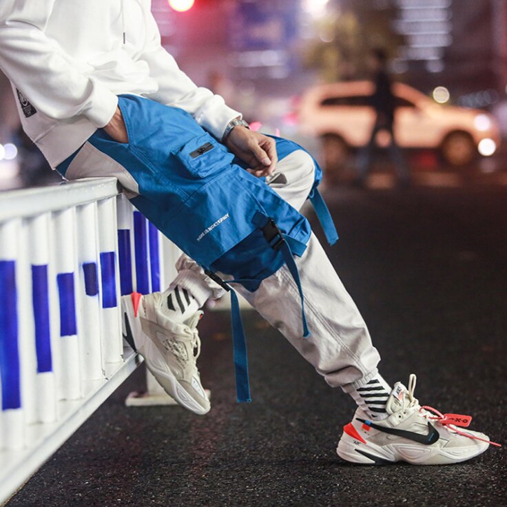 Hombres suelta ropa informal estilo Hip hop coreano pantalones Harem con bolsillo pantalones de tobillo de longitud de remiendo Casual Cargo pantalones de chándal