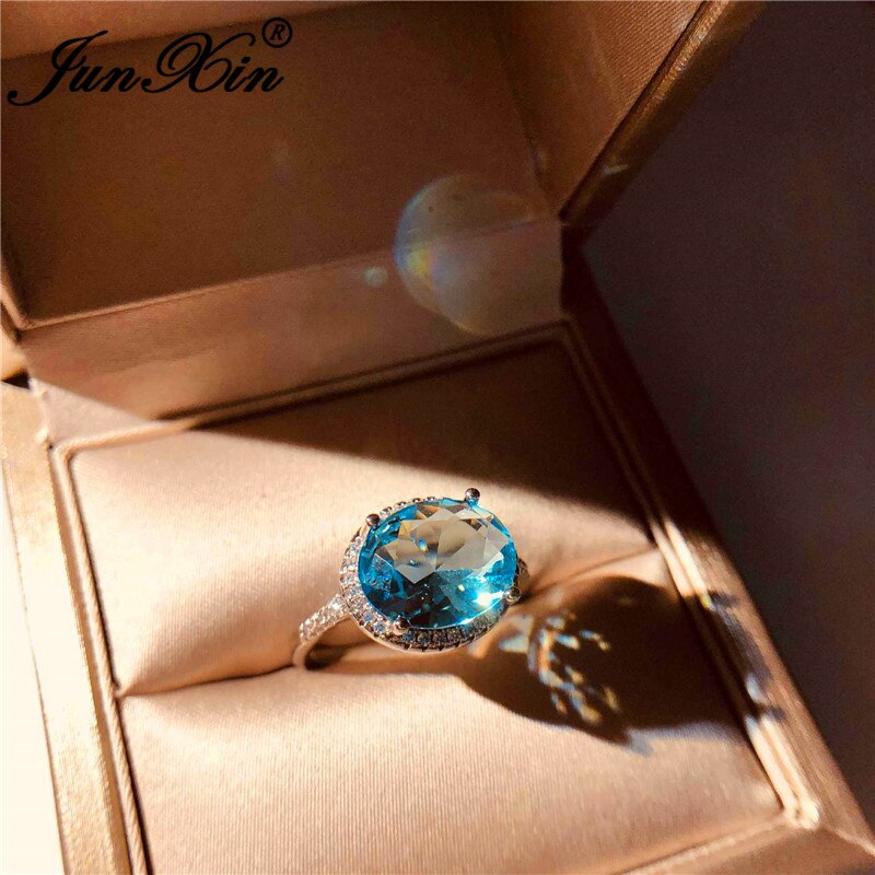 JUNXIN-Anillo de boda de una sola piedra para mujer, sortija de boda de cristal azul Aqua de corte ovalado, joyería de compromiso