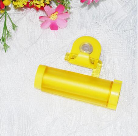 5 farver plastrulle rørpresser nyttig tandpasta let dispenser badeværelse tandpasta holder badeværelse tilbehør: Orange