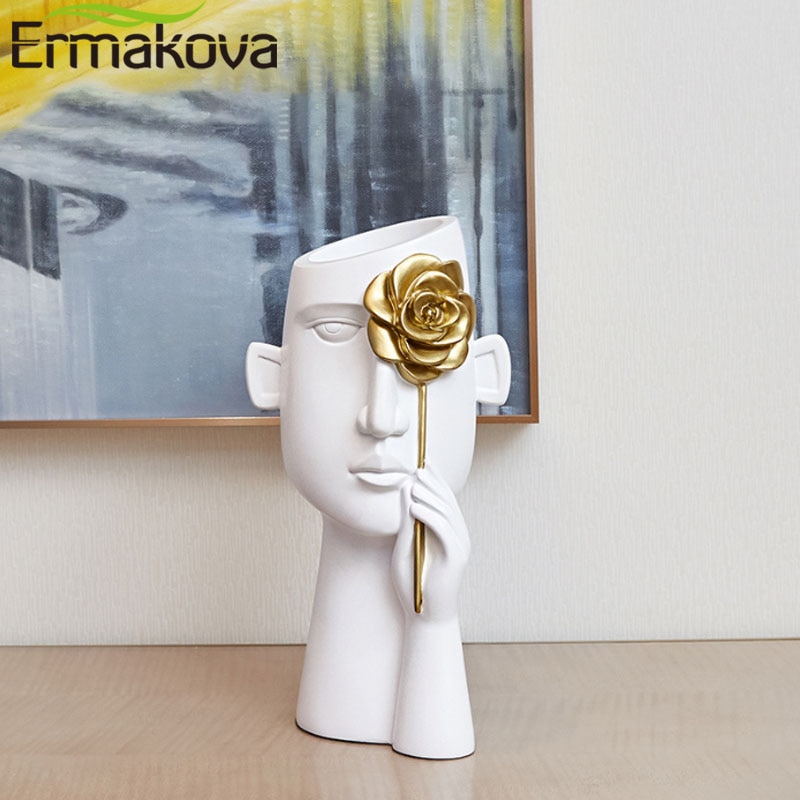 Ermakova minimalistisk portræt vaser harpiks skulptur sort menneskehoved vase gryde kontorbord blomsterarrangement boligindretning.