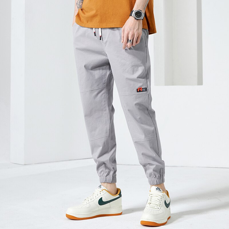 Moda Off White Casual Harem Pants męskie spodnie do biegania męskie Slim japońska moda uliczna kieszonkowe aplikacje Casual spodnie Harajuku