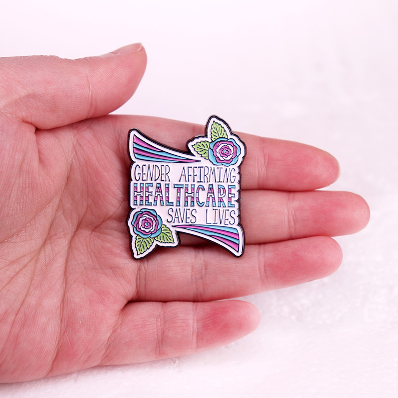 Könsbekräftande sjukvård räddar liv emaljnål brosch smycken