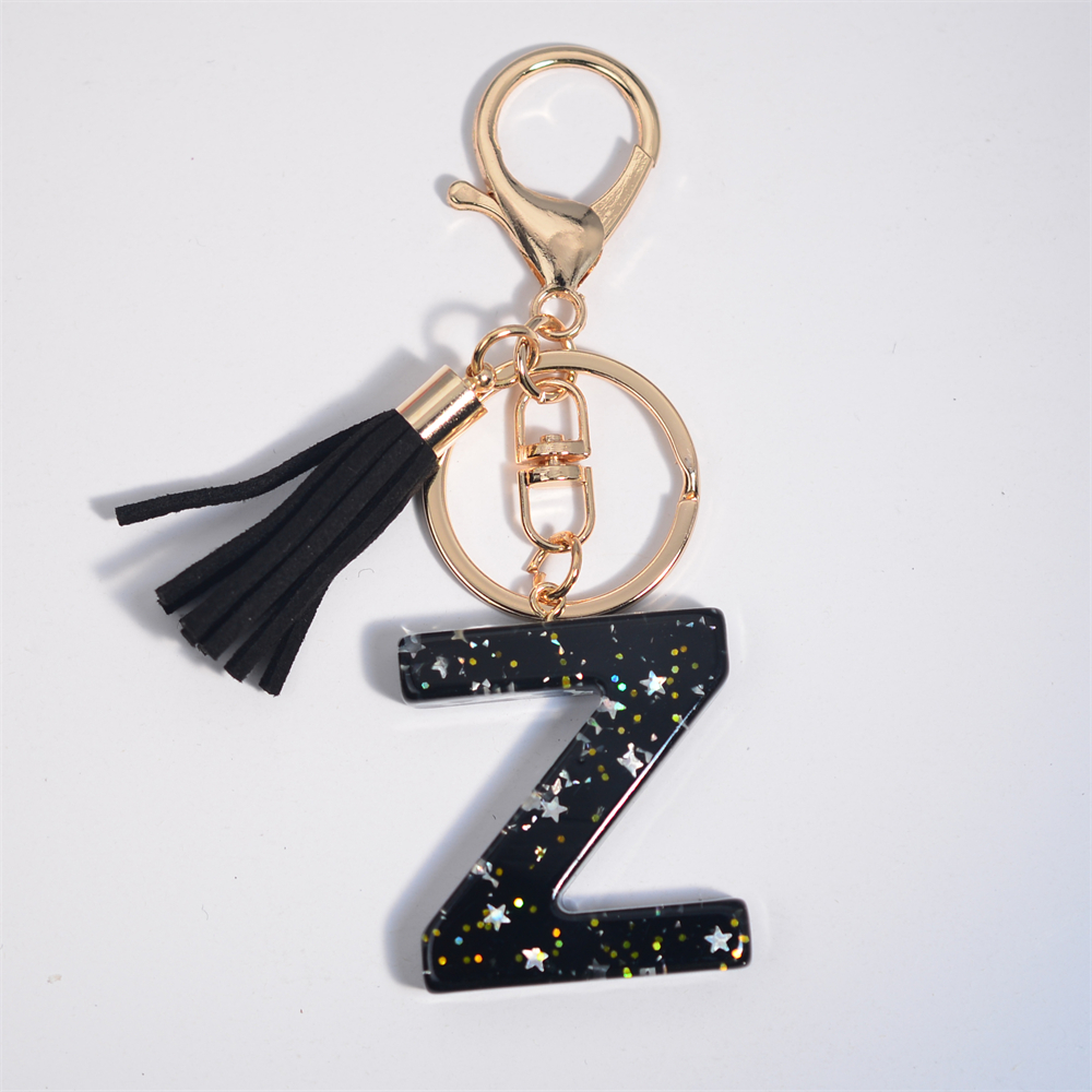 Schwarze Initialen A-Z Schlüsselanhänger Glitzer Stern Pailletten Harz Buchstaben Schlüsselanhänger mit Quaste für Frauen Tasche Ornamente Charm Autoschlüsselhalter