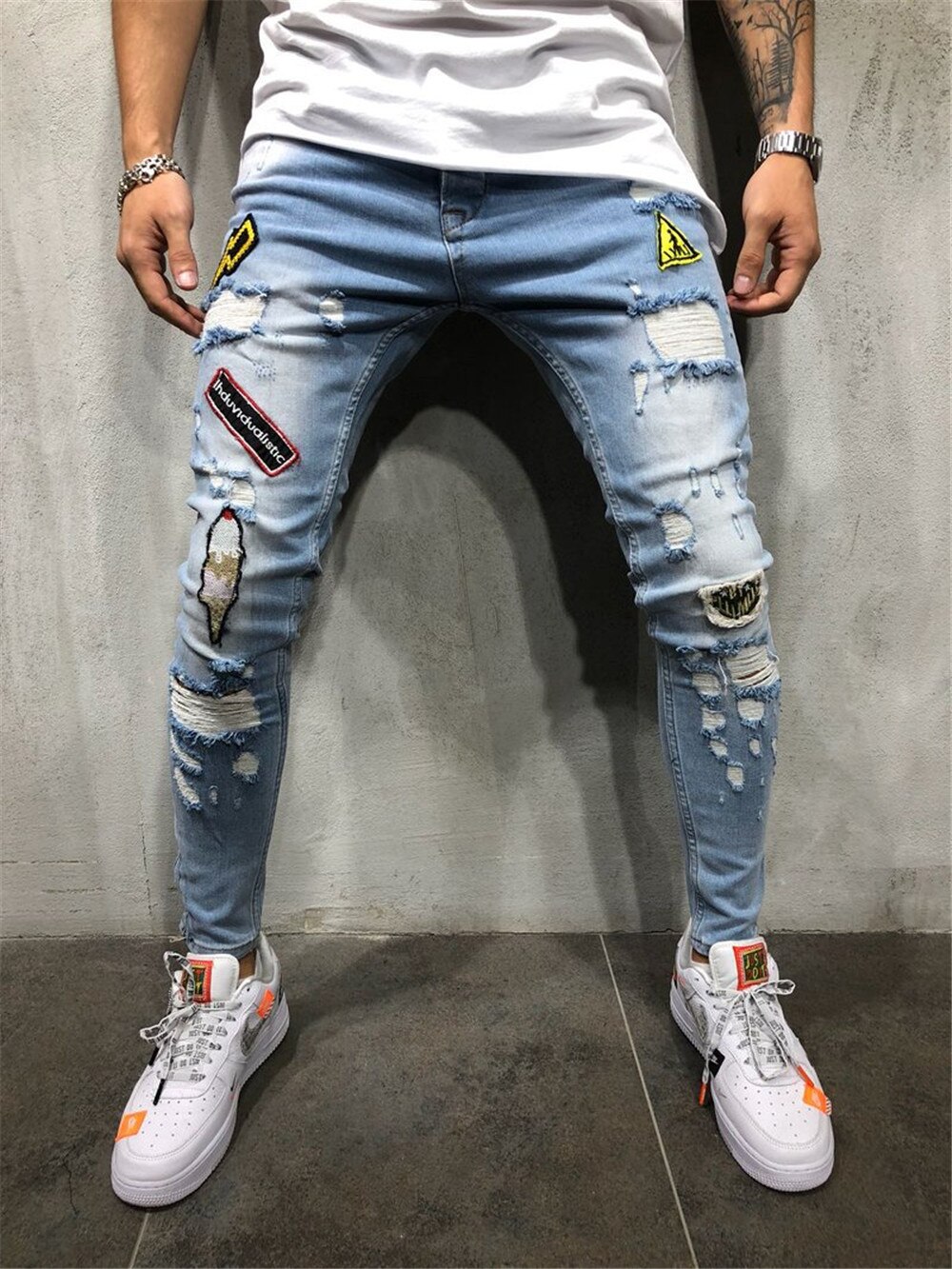 Pantalones vaqueros rasgados con agujeros para hombre, Jeans ajustados de mezcla de algodón, estilo Hip Hop, ropa de calle con insignia de retales, desgastados, color azul