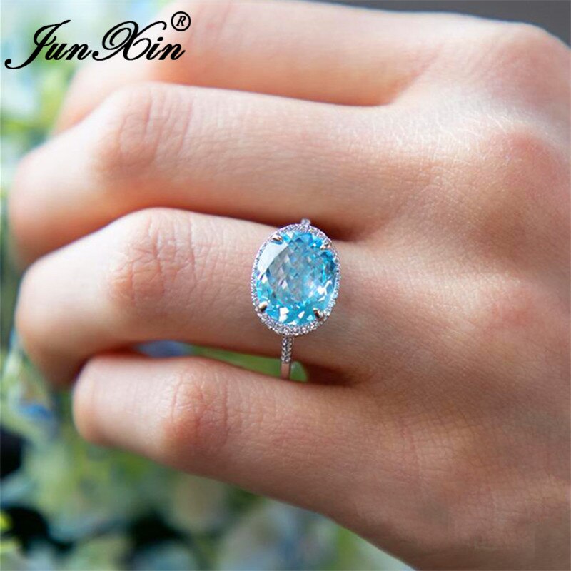 JUNXIN-Anillo de boda de una sola piedra para mujer, sortija de boda de cristal azul Aqua de corte ovalado, joyería de compromiso