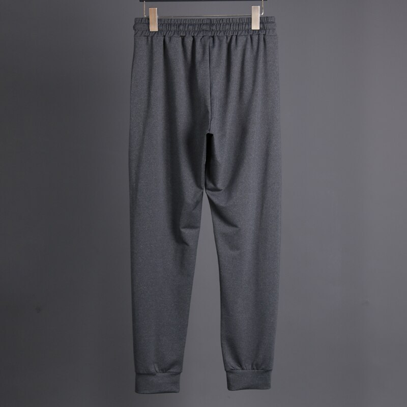 Pantalons longs en cours d'exécution hommes Polyester mince Sport entraînement Joggers poches solides pantalons de survêtement Compression hommes pantalons décontractés