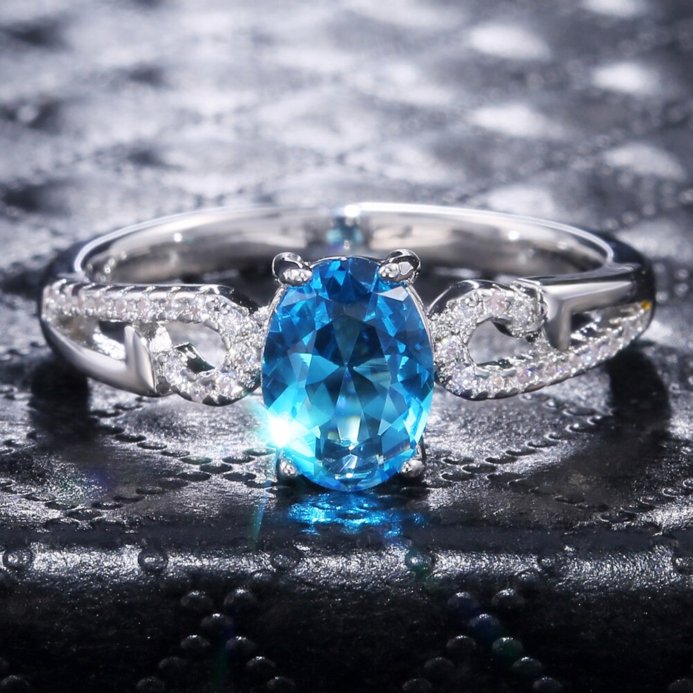 Huitan-anillo de compromiso clásico con piedras ovaladas para mujer, joyería de lujo con Micro incrustaciones de nubes, color azul cielo, CZ