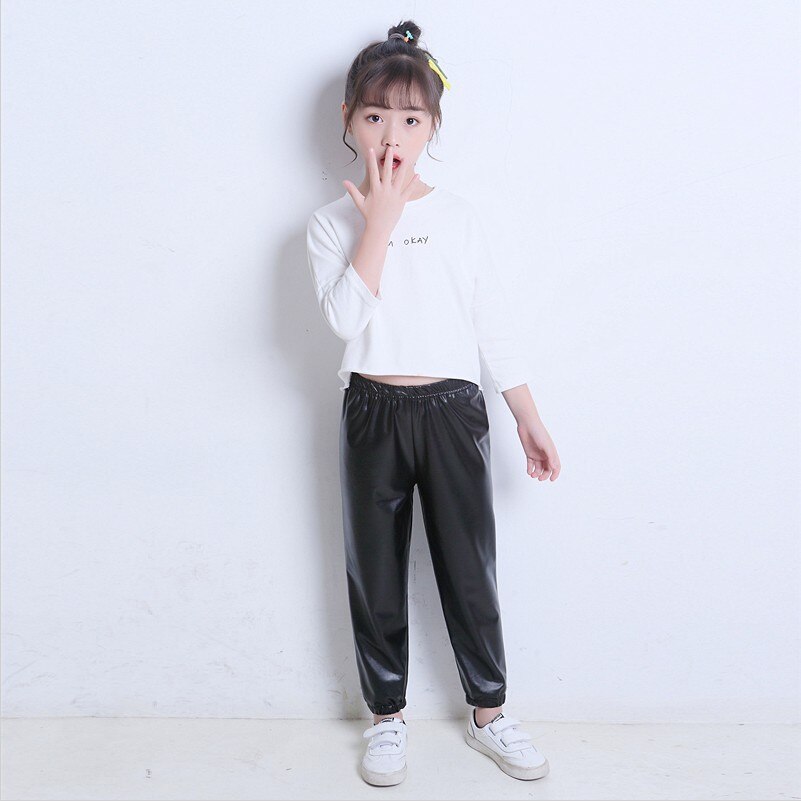 Del bambino del bambino del bambino del bambino della ragazza black stretch in pelle artificiale close-lato di modo allentato pantaloni