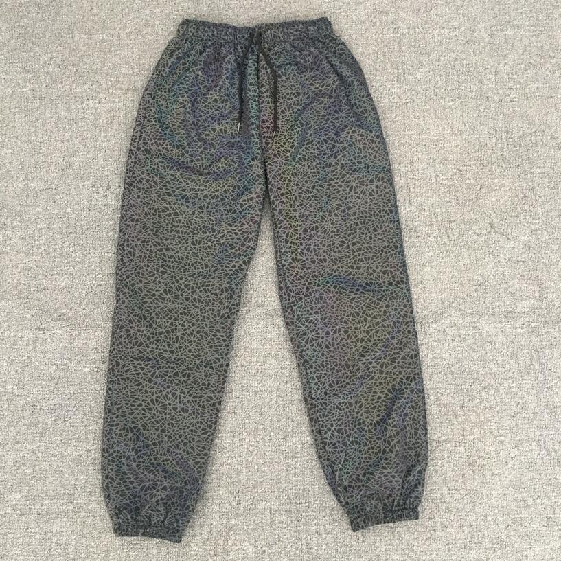 Pantalones Jogger informales luminosos coloridos de hip-hop para hombres europeos y americanos con patrón caótico reflectante