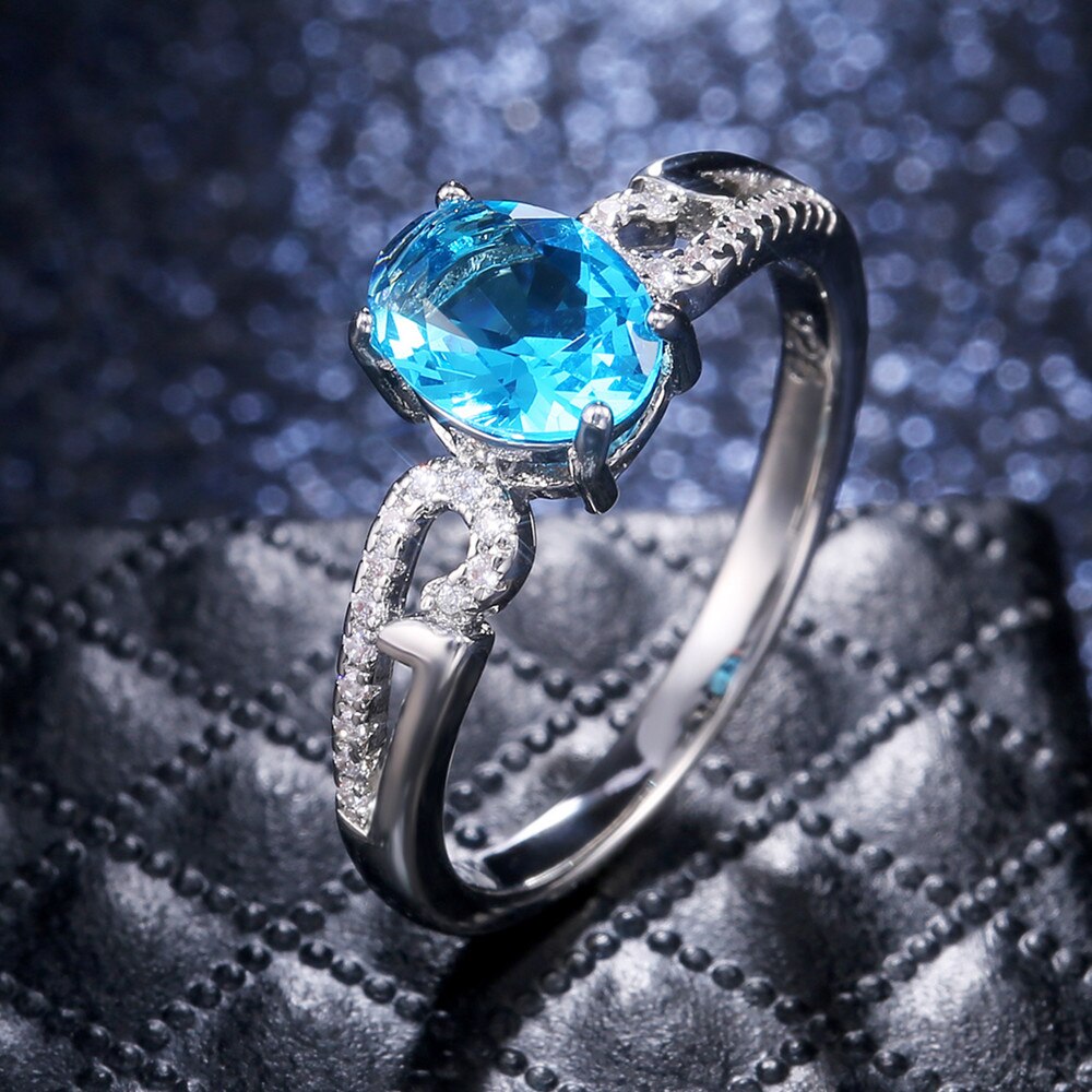 Huitan-anillo de compromiso clásico con piedras ovaladas para mujer, joyería de lujo con Micro incrustaciones de nubes, color azul cielo, CZ