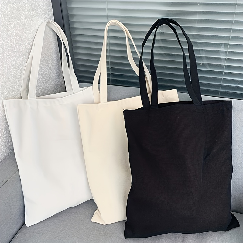 Einfache und lässige einfarbige Segeltuch-Material-Handheld-Umhängetasche für Damen mit großer Kapazität zum Einkaufen und Reisen