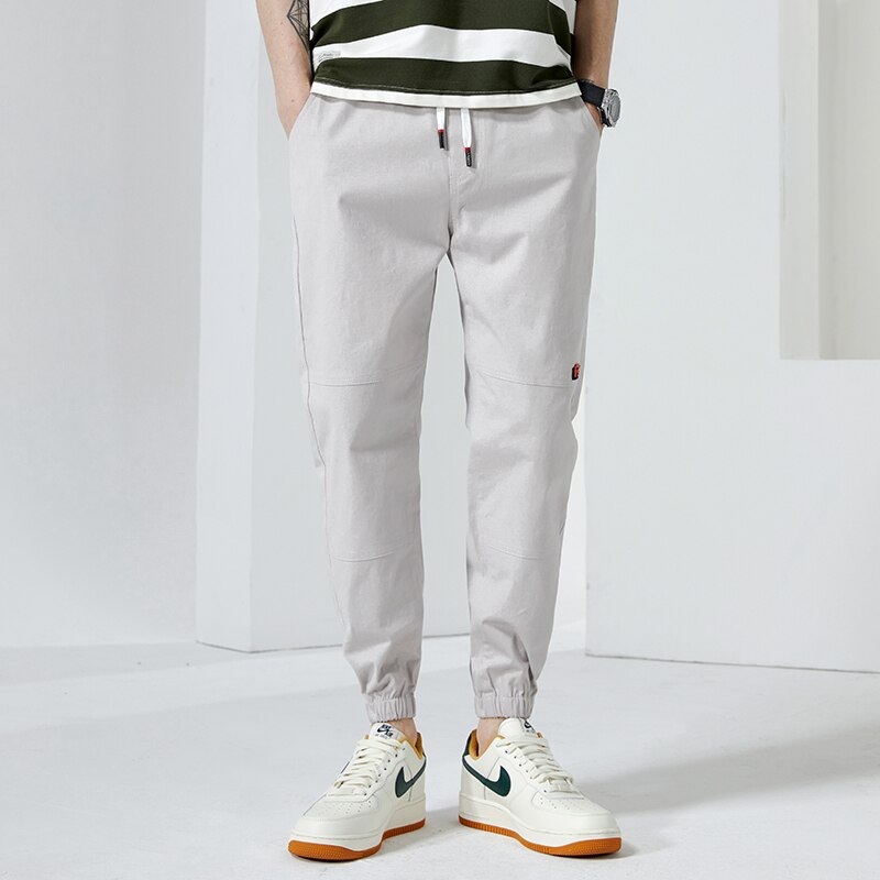 Moda Off White Casual Harem Pants męskie spodnie do biegania męskie Slim japońska moda uliczna kieszonkowe aplikacje Casual spodnie Harajuku