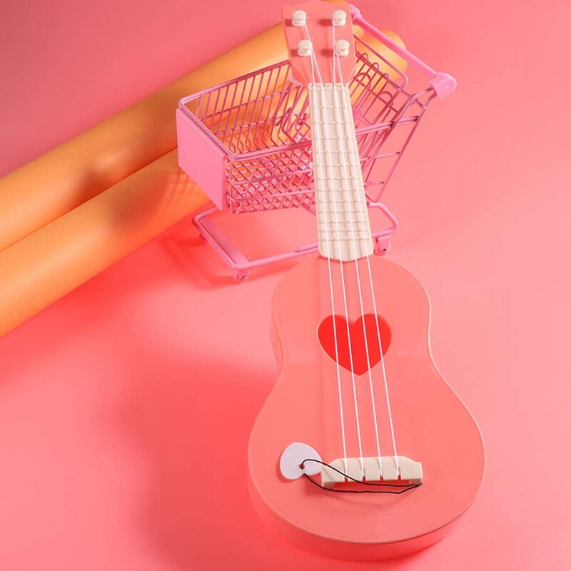-minigitarr ukulele leksak musikinstrument lärande gitarr leksaker för barn kan locka barns uppmärksamhet (rosa)