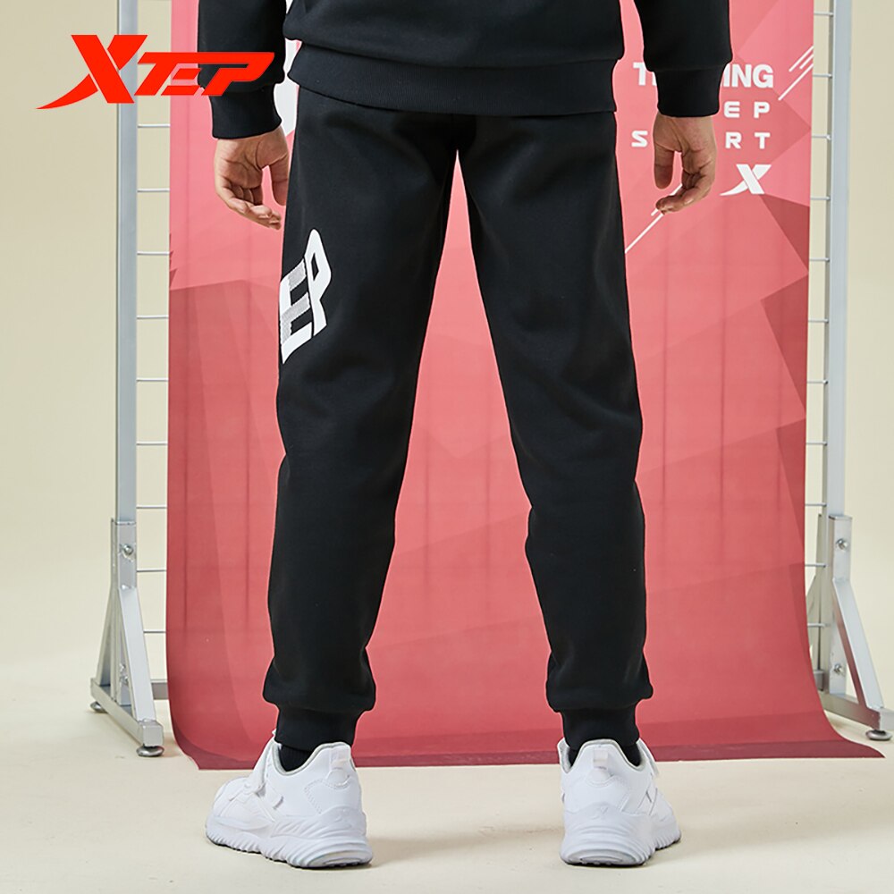 Spodnie dziecięce Xtep 2020 jesienne i zimowe spodnie chłopięce plus kaszmir ciepły tendencja zwykły spodnie sportowe 680426639028