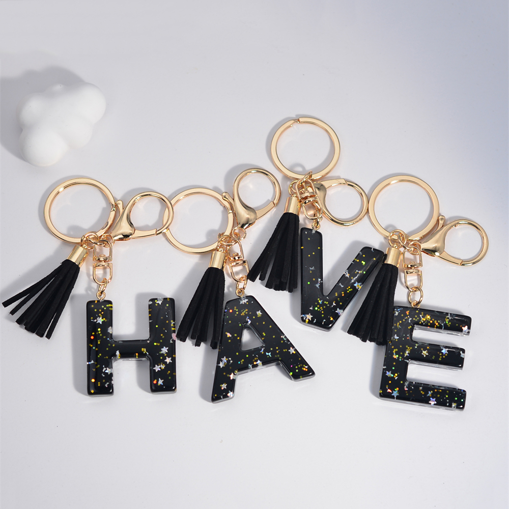 Schwarze Initialen A-Z Schlüsselanhänger Glitzer Stern Pailletten Harz Buchstaben Schlüsselanhänger mit Quaste für Frauen Tasche Ornamente Charm Autoschlüsselhalter