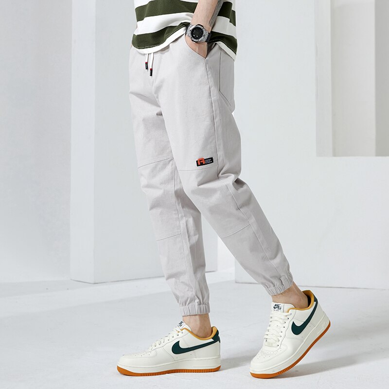 Moda Off White Casual Harem Pants męskie spodnie do biegania męskie Slim japońska moda uliczna kieszonkowe aplikacje Casual spodnie Harajuku