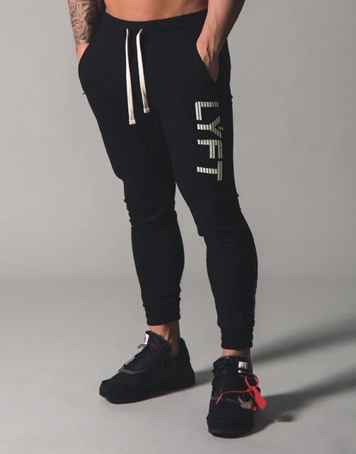 Miesten verkkarit, fitness-, kehonrakennus- ja vapaa-ajan housut, printtihousut, collegehousut, puuvillaiset verkkarit, kapea istuvuus, streetwear-housut