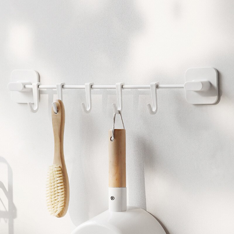 A row of hook storage rack on the wall without pun... – Grandado