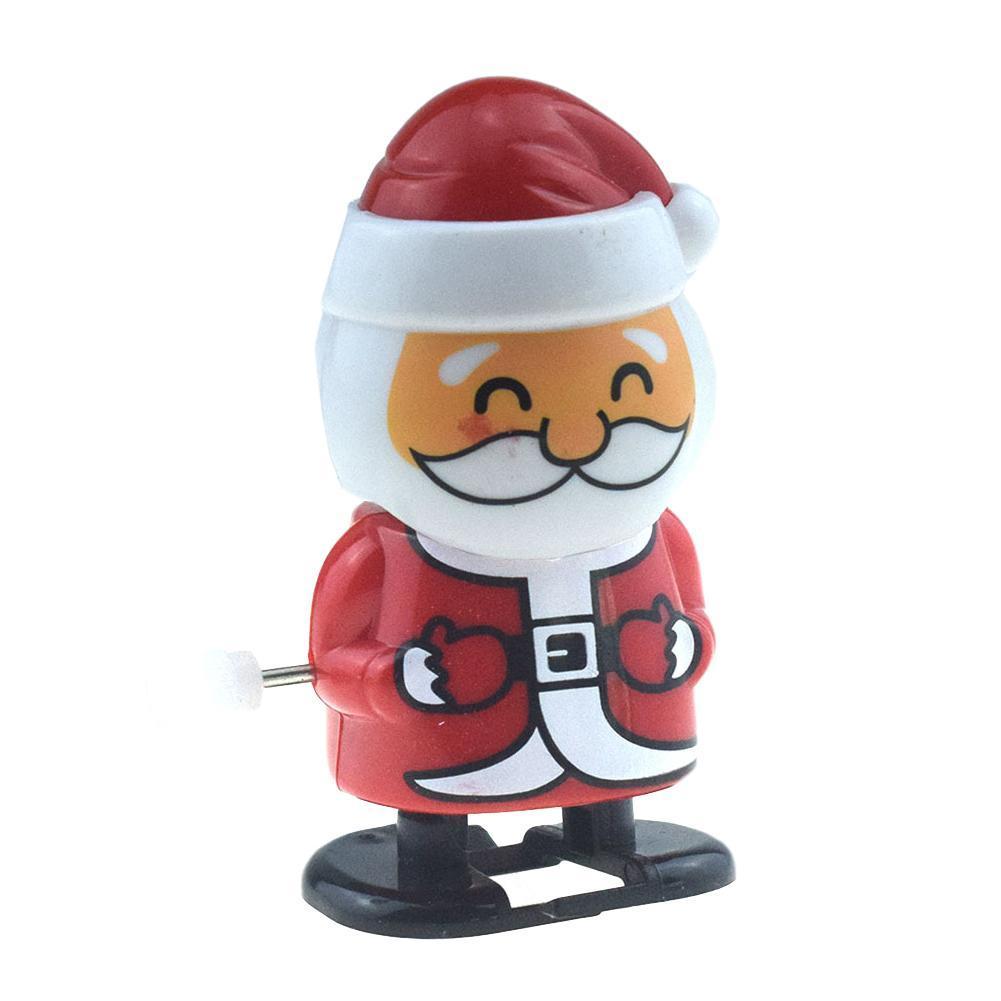 Schattige opwindbare kerstman schudt zijn hoofd en loopt met een speelgoed kerstman en sneeuwpop  c2 i 9
