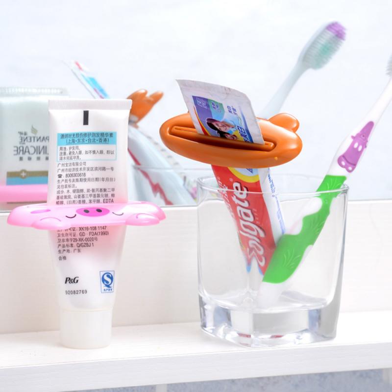 1pc tegneserie tandpasta dispenser tandpasta squeezers tube rullende holder squeezer plast tandpasta tube squeezer