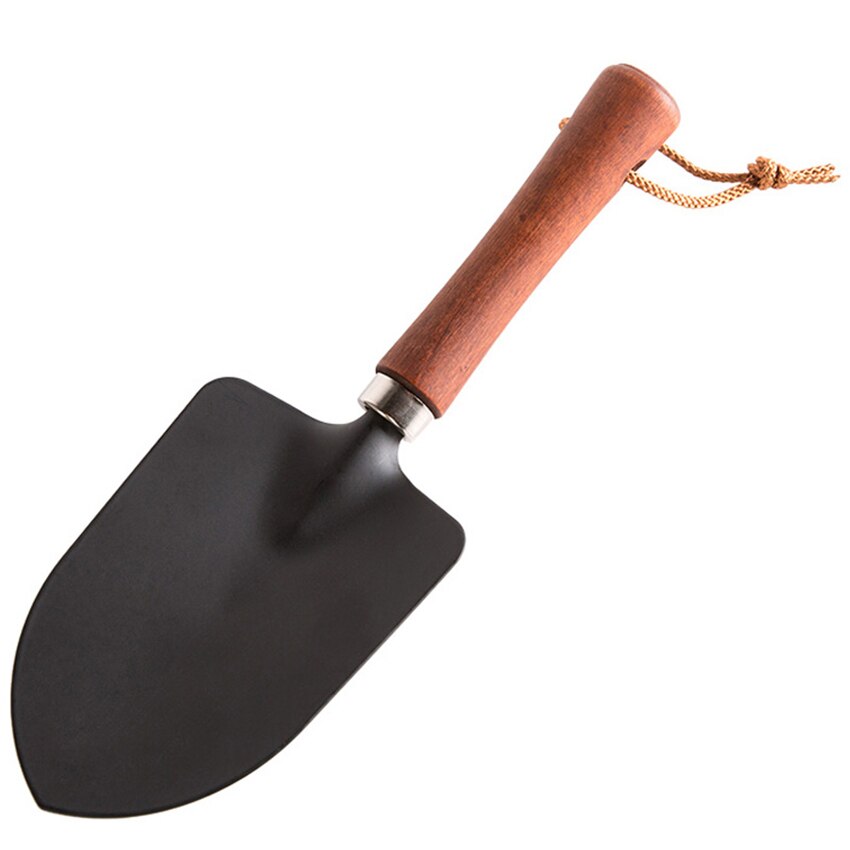 Trähandtag liten spade balkong plantering blommor ogräsrensning trädgårdsredskap hushåll köttiga krukor lös jord järn utgrävning spade