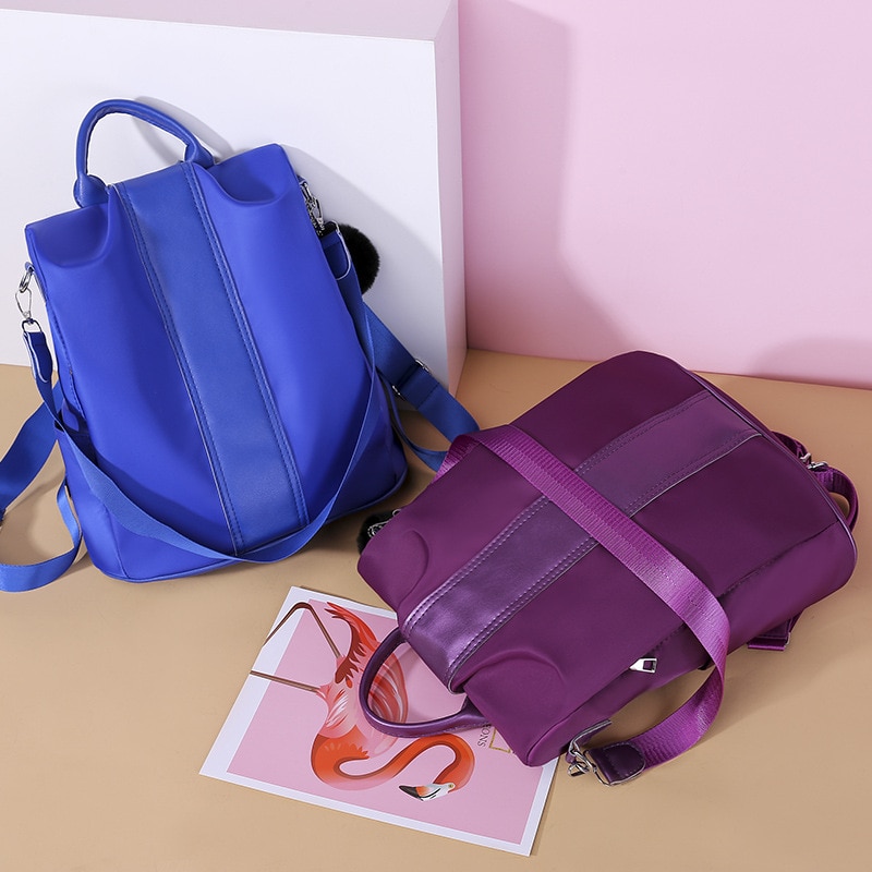 Mochila antirrobo para niñas, bolso escolar Oxford, color morado, colgante rosa, impermeable, de viaje
